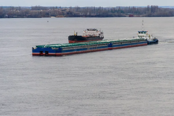 Cargo ship and barge sailing on the river Dnieper