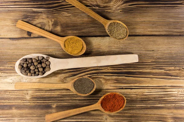 Surtido de especias en cucharas de madera sobre una mesa — Foto de Stock