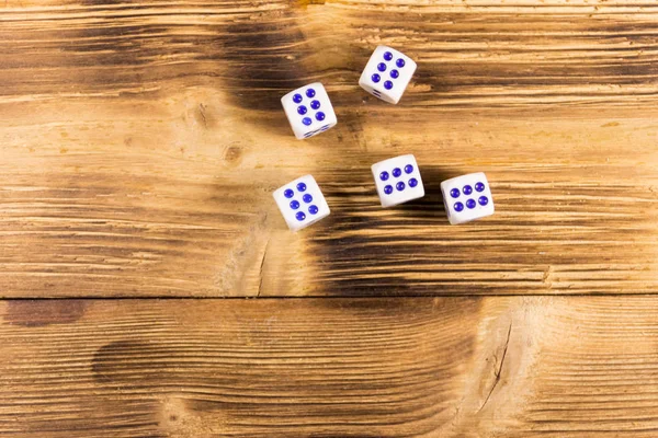White dice on wooden table. Game of chance concept
