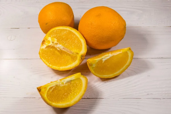 하얀 나무 탁자 위에 있는 신선 한 오렌지 — 스톡 사진