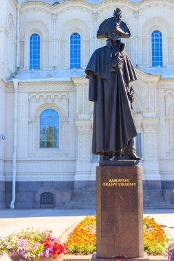 Monument to russian admiral Fyodor Ushakov in front of the Naval cathedral of St. Nicholas in Kronstadt, Russia. Inscription: To Admiral Fyodor Ushakov clipart