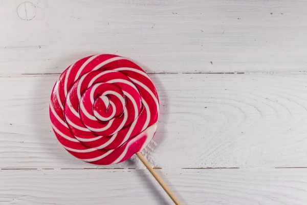 Sweet lollipop on white wooden background. Top view — Stock Photo, Image