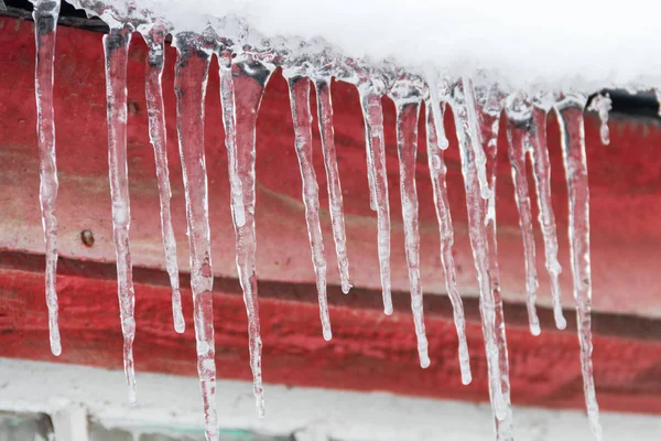 Icicles hanging from roof — Stock Photo, Image