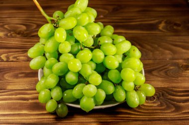 Tahta bir tabakta taze beyaz üzüm.