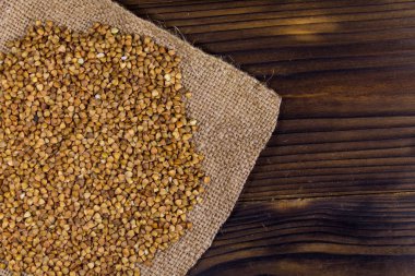 Ahşap masada güpepeçete üzerinde çiğ karabuğday