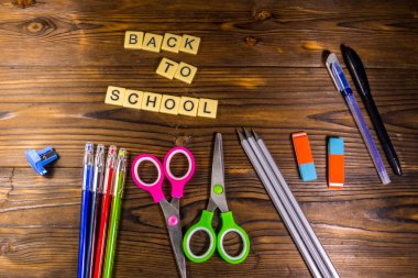 Okula geri ile okul yazıt, kalem, kalem, makas, silgi üzerinde ahşap masa seti