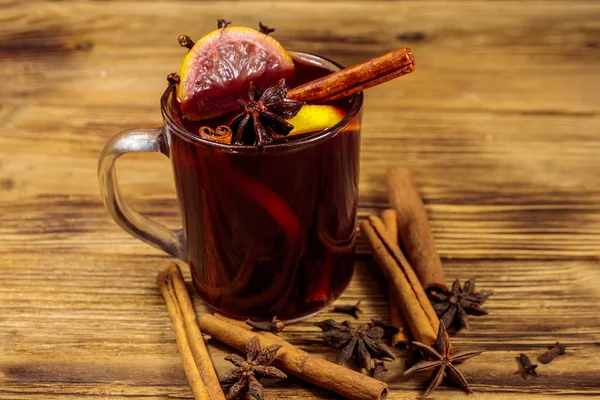 Mulled wine and spices on wooden table — Stock Photo, Image