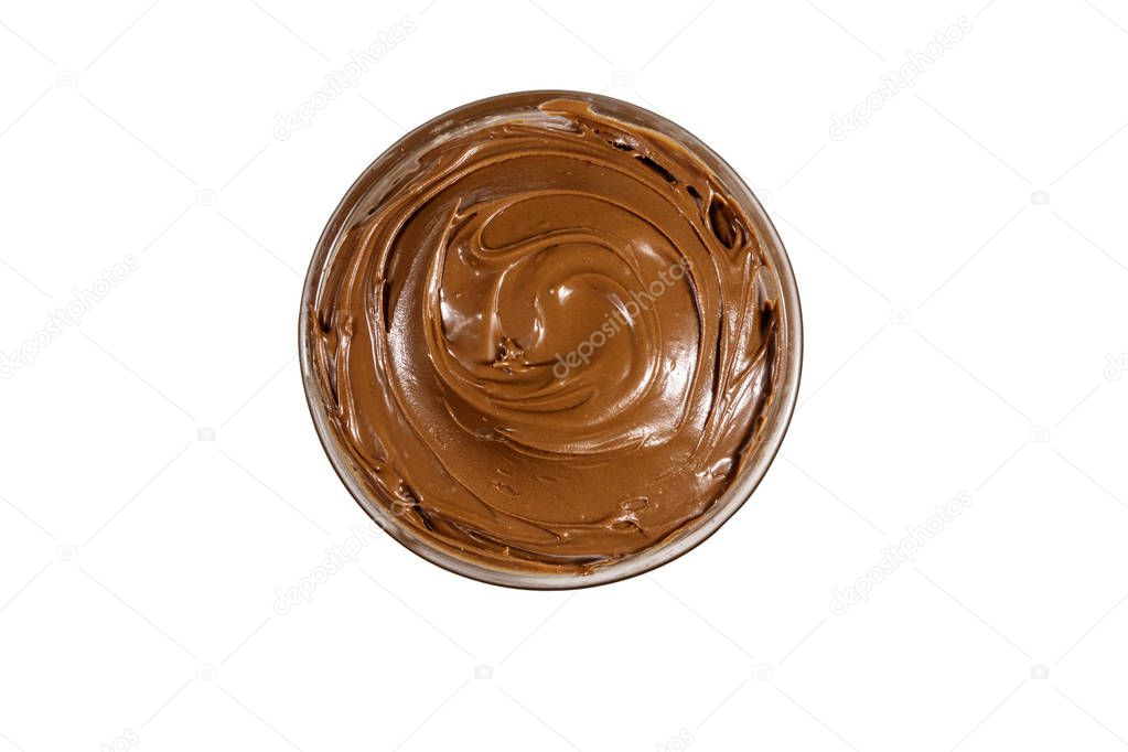 Glass bowl with delicious chocolate hazelnut spread isolated on white background. Top view
