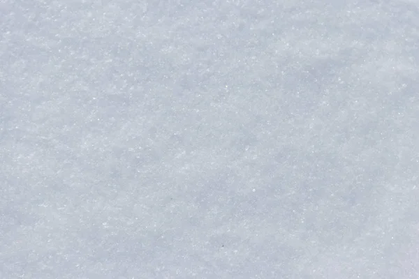 Struktura bílého sněhu. Zimní pozadí — Stock fotografie