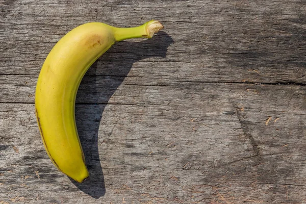 Delicious ripe yellow banana fruit on rustic wooden table — Stock Photo, Image