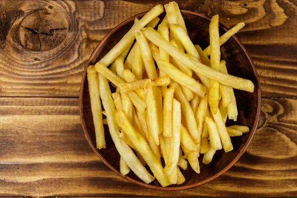 Batatas fritas na mesa de madeira — Fotografia de Stock