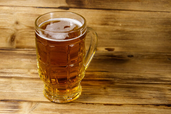 Mug of beer on a wooden table