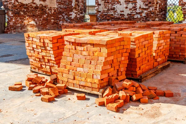 Stacks of new red brick at construction site — 스톡 사진