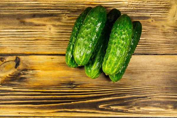 Fresh cucumbers on wooden table — Stock Photo, Image