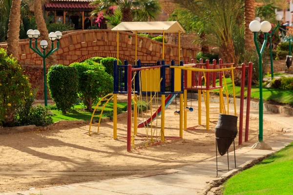 Colorful playground equipment for children in tropical holiday resort — Stock Photo, Image