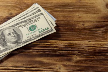 Tahta masadaki 100 dolarlık banknotlar.