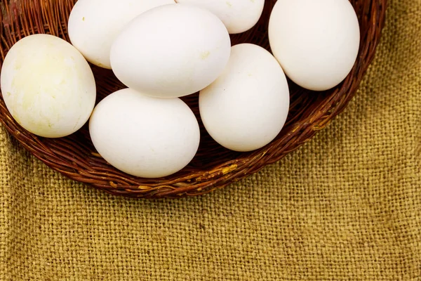 White Chicken Eggs Wicker Basket Sackcloth Background — Stock Photo, Image
