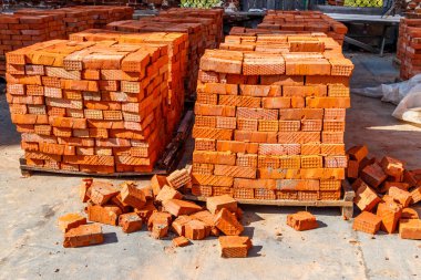 Stacks of new red brick at construction site