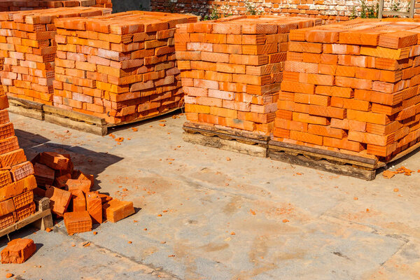 Stacks of new red brick at construction site