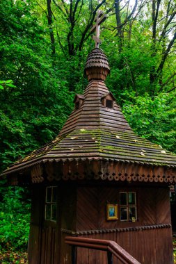 Small wooden orthodox chapel at holy spring in green forest in Shamordino, Kaluga Oblast, Russia