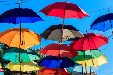Şehir caddesinde çok renkli şemsiyeler. Şehir caddesi birçok renkli açık şemsiyelerle süslenmiştir.