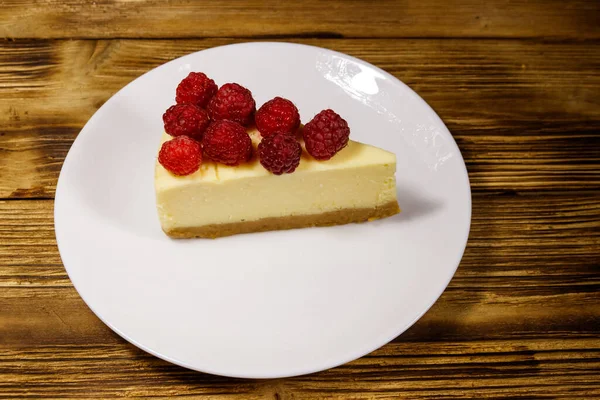 Piece Tasty New York Cheesecake Raspberries White Plate Wooden Table — Stock Photo, Image