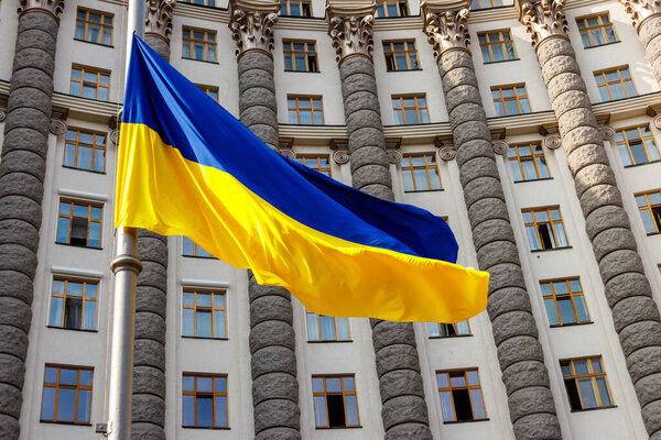 Flag of Ukraine against the Cabinet of Ministers of Ukraine building