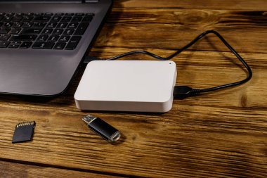 Harici HDD dizüstü bilgisayara, hafıza kartına ve USB flash diske bağlı. Veri depolama kavramı