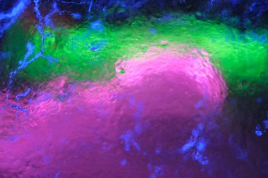 Aydınlatılmış şeffaf şeffaf renkli çatlak buz dokusunun soyut arkaplanı