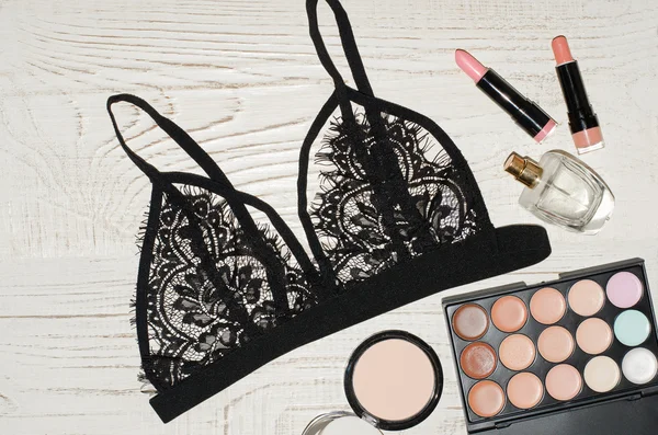 Fashion image, lace underwear, eye shadow, perfume and lipsticks. View from above — Stock fotografie