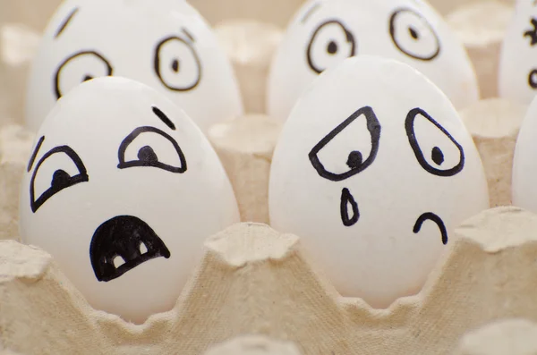 Eggs with the drawn emotions, frightened and crying face