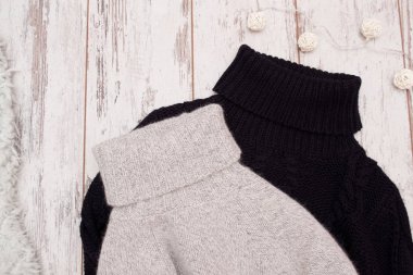 İki ahşap arka plan üzerinde bir yakalı kazak ördü. Moda kavramı, üstten görünüm