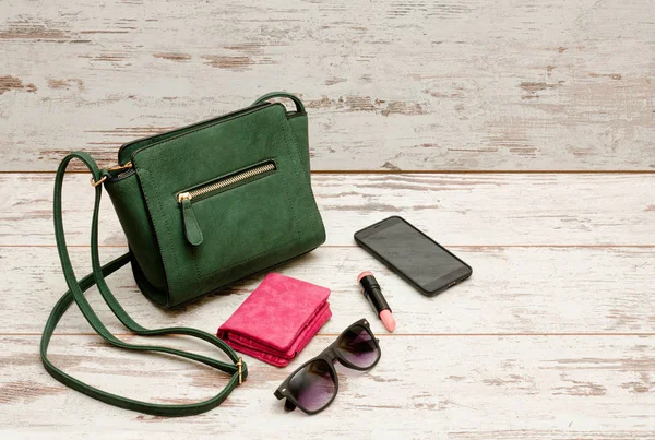 Modisches Konzept: Lidschatten, Handtasche, Brille, Lippenstift, Geldbörse auf Holzgrund. Ansicht von oben — Stockfoto