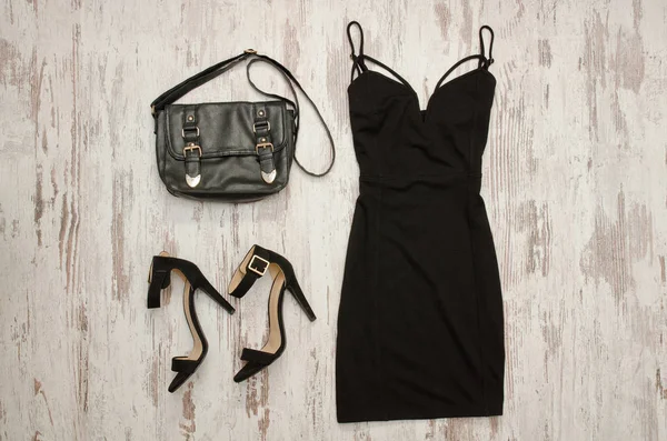 Black dress, bag and black shoes. Fashionable concept