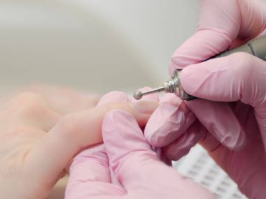 Ellerinde eldiven işleme freze kesici manikür çivi