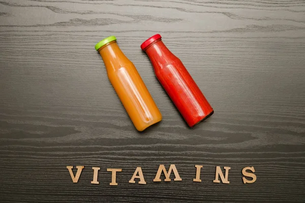 İki şişe suyu ve yazıt vitaminler ahşap zemin, gıda kavramı ile