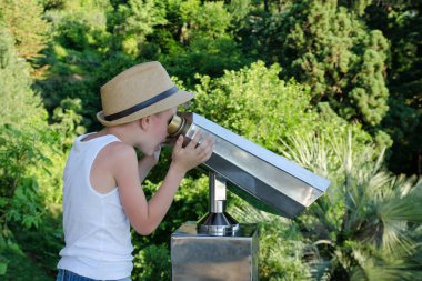 Dürbün iki büyük bir şapkalı çocuk. Yeşil arka planı
