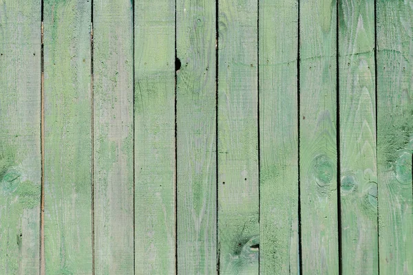 Vertical gray-green boards, faded paint. Texture. Background