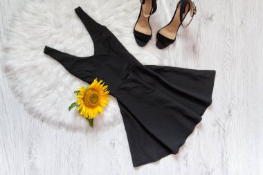 Black short and shoes on white fur sunflowers. Fashionable concept clipart