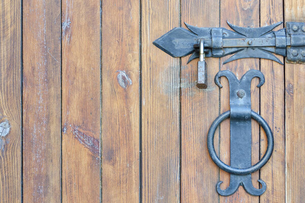 Wooden door, close-up. Metal handle and lock.