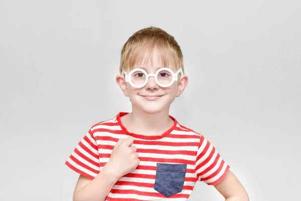 Garçon en t-shirt rayé et lunettes sur fond blanc — Photo