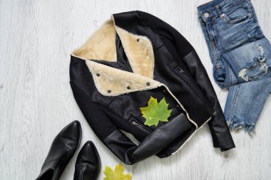 Siyah ceket, Ayakkabı, kot pantolon ve akçaağaç yaprakları. Moda kavramı