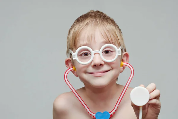 Leuke jongen speelt arts. Speelgoed bril en phonendoscope. Portret — Stockfoto