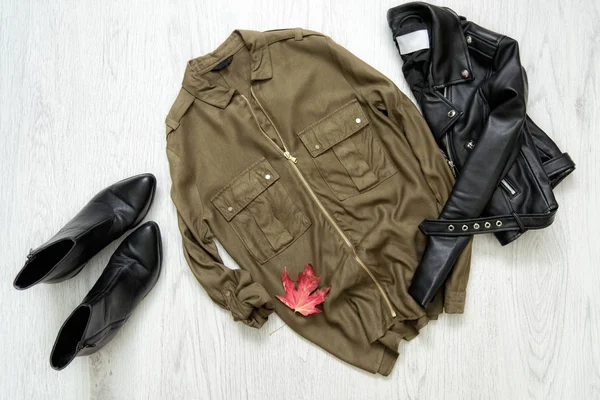 Khaki shirt, black jacket and shoes. Fashionable concept