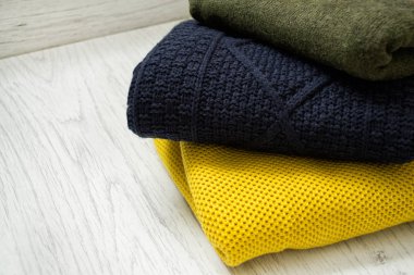 Ahşap arka plan üzerinde üç sıcak renk kazak