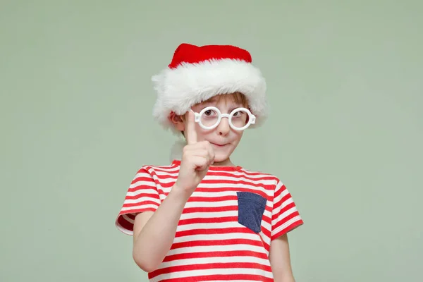 Chłopiec w Santa's kapelusz i okulary. Podniósł palec — Zdjęcie stockowe