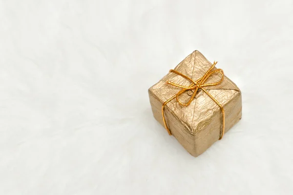 Golden gift box on a white background, copy space Stock Image