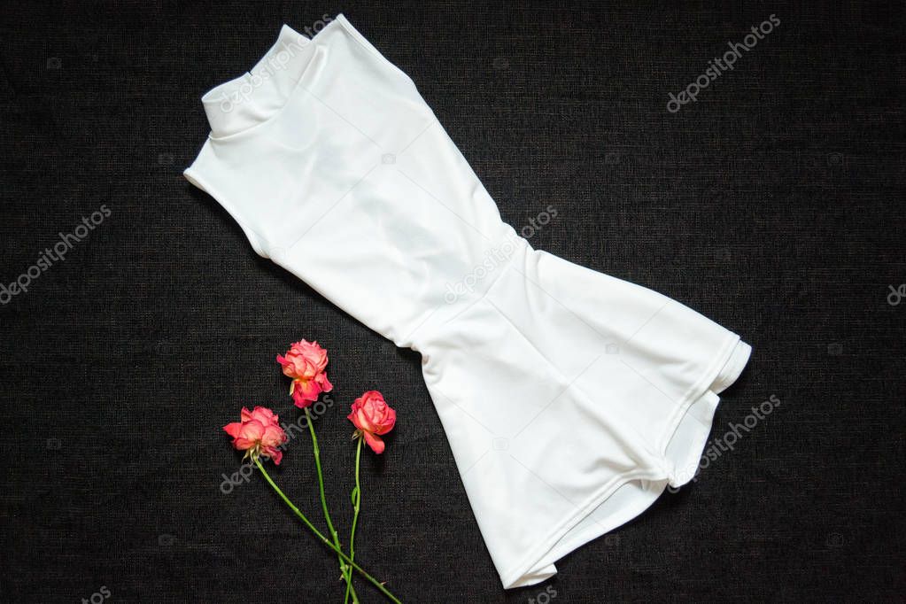 White overalls on a black background, roses. Fashionable concept