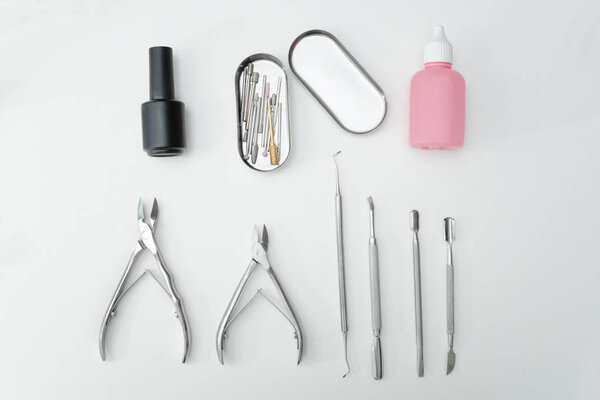 Manicure set. Tools, scissors and care products. White background