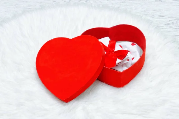 Red gift box in the shape of heart. Underwear and candles — Stock Photo, Image